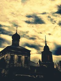 Low angle view of church against cloudy sky