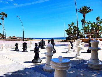 View of chess by sea against blue sky
