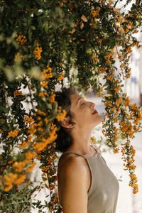 Contemplating woman standing during sunny day