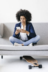 Young businesswoman using smartphone with headset