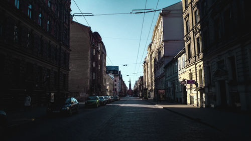 Narrow street amidst buildings in city