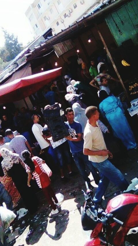 HIGH ANGLE VIEW OF PEOPLE SITTING ON WALL