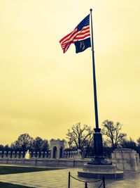 Low angle view of american flag against sky