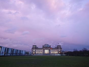 Reichstag building, seat of german parliament deutscher bundestag, during a cloudy day at sunset