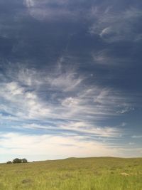 Scenic view of field against cloudy sky