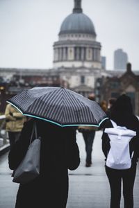 Rear view of people walking in park