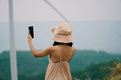 Rear view of woman photographing