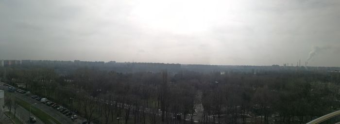 High angle view of trees against sky in city