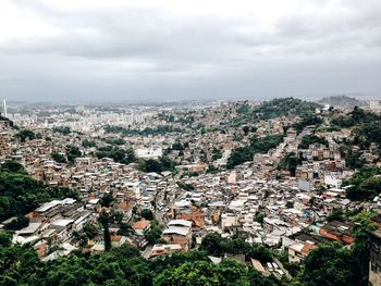 Aerial view of city against cloudy sky