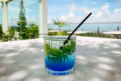 Close-up of drink on table with stunning view