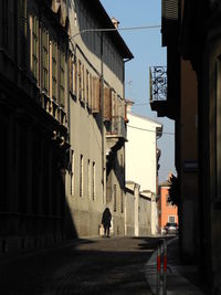 People walking on street amidst buildings in city