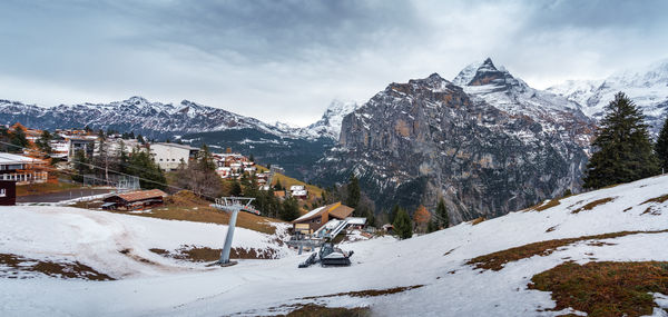 Scenic view of snow covered mountains against sky