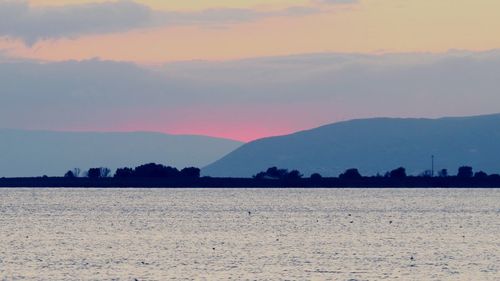 Scenic view of silhouette mountains against sky during sunset