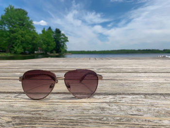 Sunglasses on beach against sky