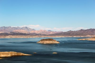 Scenic view of sea against clear blue sky