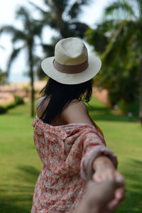 Close-up of model looking away, while trying to hold her hands.