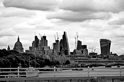 View of cityscape against cloudy sky