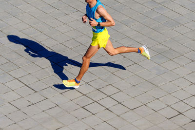 Low section of woman walking on street