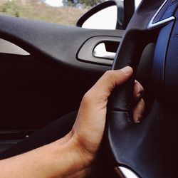 Close-up of hand holding car