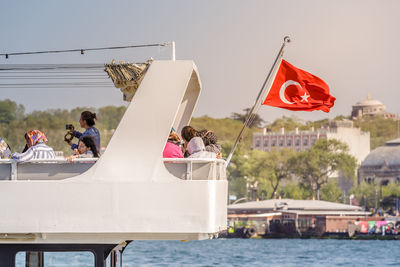 People on boat against sky