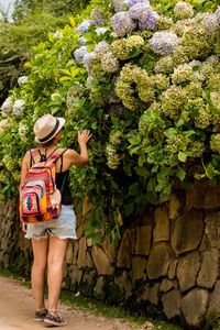 Full length of woman standing against plants