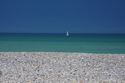 Scenic view of sea against clear blue sky