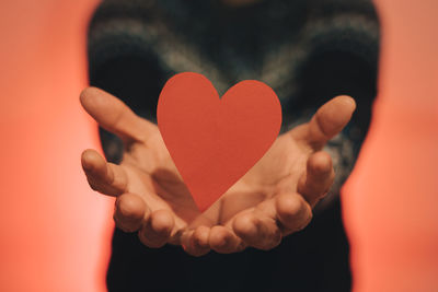 Close-up of heart shape against red background