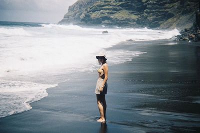 Rear view of man standing on beach