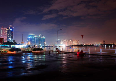 Illuminated city at waterfront