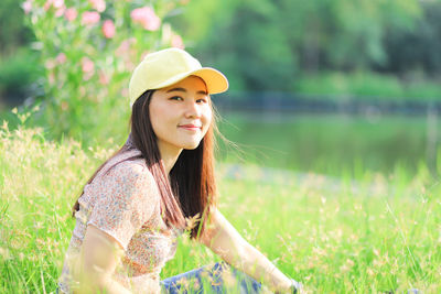 Portrait of smiling young woman on field