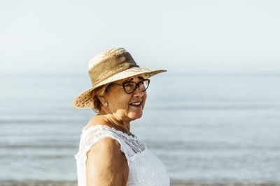 Portrait of content senior woman at the sea, el roc de sant gaieta, spain