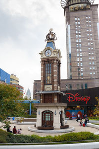 Low angle view of clock tower in city against sky