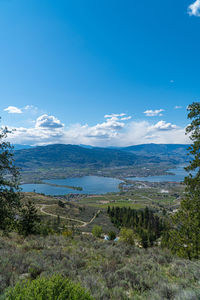 Scenic view of landscape against blue sky