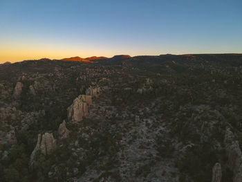 Scenic view of landscape against clear sky during sunset