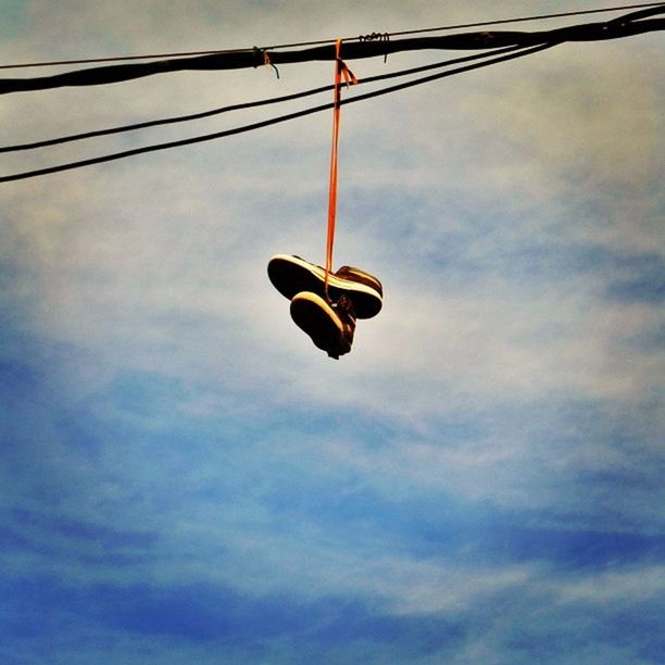 low angle view, sky, cloud - sky, cable, street light, lighting equipment, electricity, hanging, power line, cloudy, transportation, pole, technology, cloud, road signal, outdoors, silhouette, mid-air, power cable, power supply