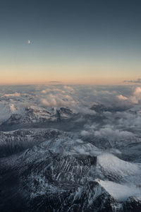 Aerial view of clouds over mountain against sky during sunset