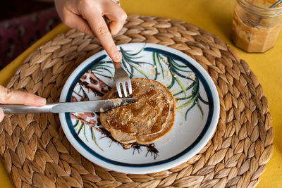 High angle view of person having breakfast on table