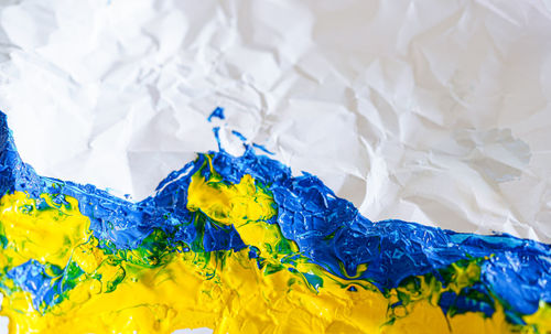 Crumpled paper with ukrainian flag