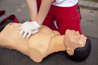 Low section of woman applying cpr on dummy