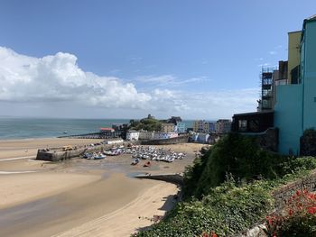 High angle view of beach by buildings against sky