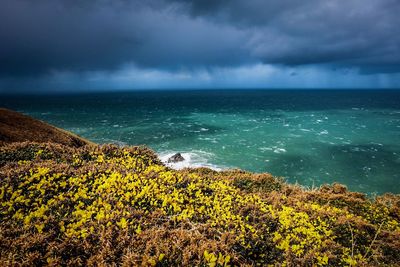 Scenic view of sea against storm clouds