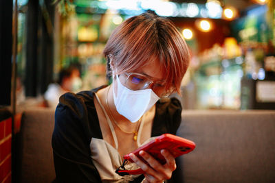 Portrait of young woman wearing mask