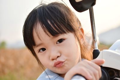 Close-up portrait of cute baby girl outdoors