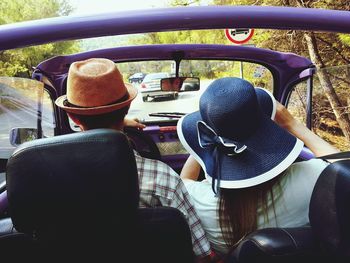 Rear view of man sitting in car