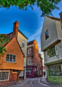 Street amidst buildings against sky