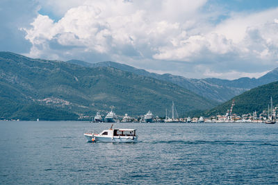 Scenic view of sea and mountains against sky