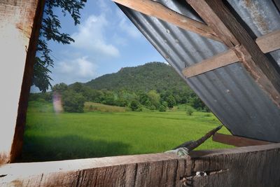 Scenic view of field against sky seen through window