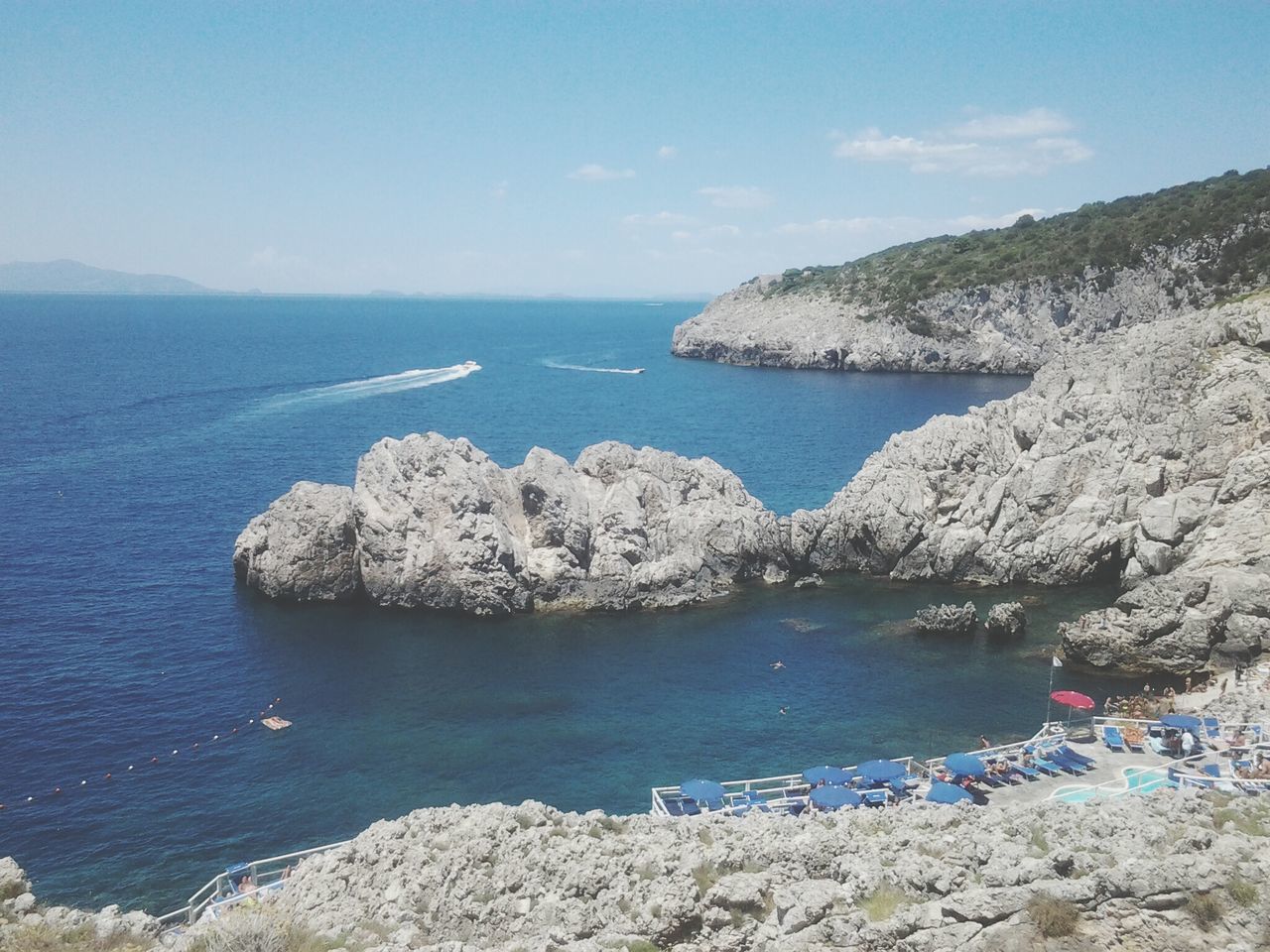 sea, water, horizon over water, tranquility, tranquil scene, scenics, beauty in nature, rock - object, sky, nature, rock formation, blue, beach, shore, idyllic, rock, high angle view, cliff, day, coastline