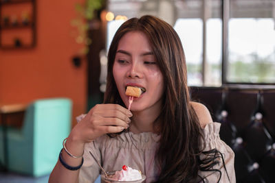 Portrait of woman eating food