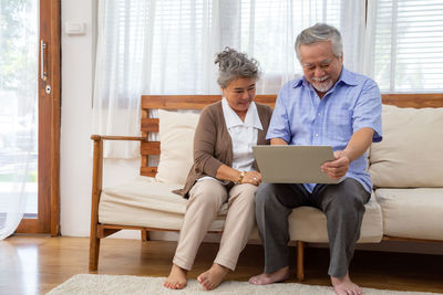 Friends looking away while sitting at home
